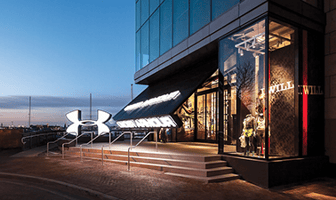 Canopy Type Bifold Garage Doors by Schweiss Doors Installed in Under Armor Storefront in Baltimore